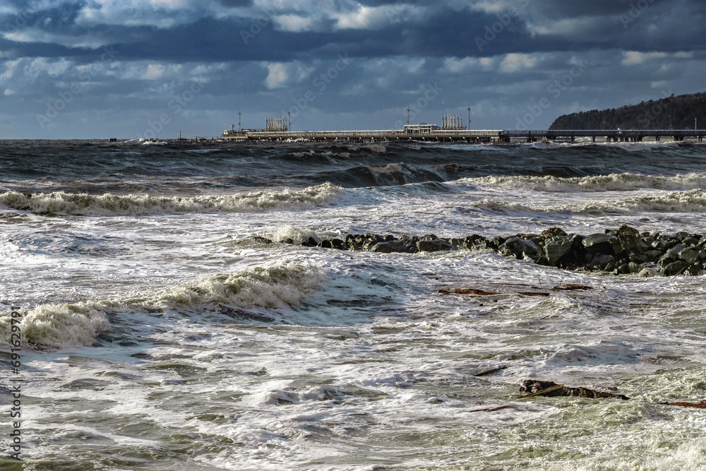 The Black Sea during a storm. An epic seascape. Beautiful sea waves during a storm. Big waves crash on the shore under a cloudy sky. View of the stormy seascape. Large sea waves during a storm.