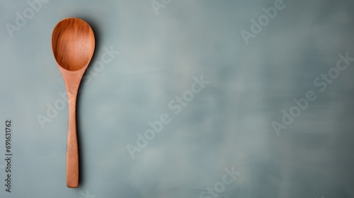  a wooden spoon sitting on top of a blue wall next to a wooden spoon with a wooden spoon rest on top of a blue wall next to a wooden spoon.