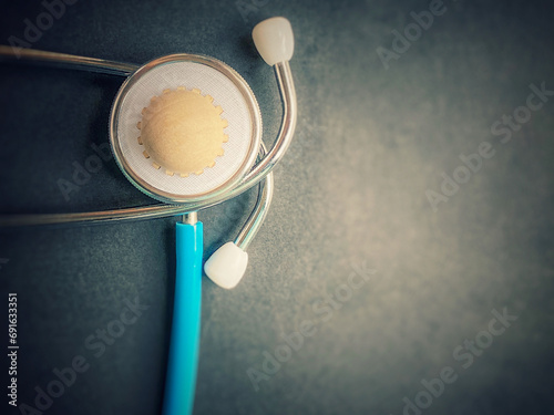 stethoscope with wooden COVID-19 object on it in vintage background. Healthcare Awareness Concept.  photo
