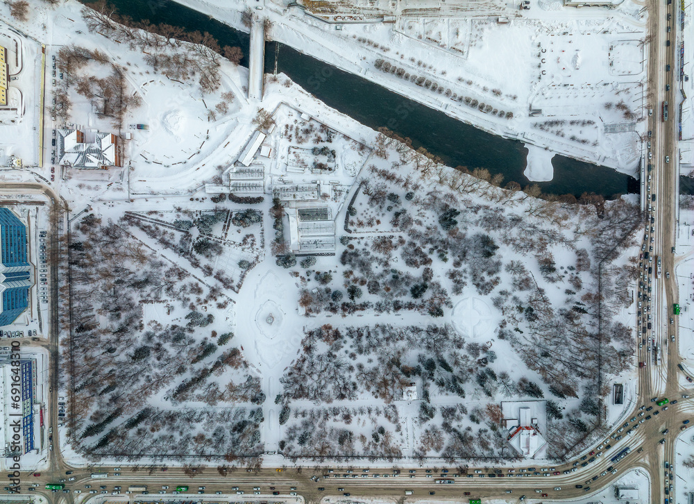 Small park with bare trees covered with snow. Aerial view to winter park in Yekaterinburg