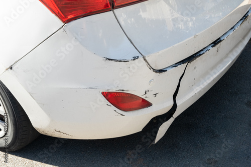 A broken damaged rear bumper on a car, damage often encountered in road accidents. photo