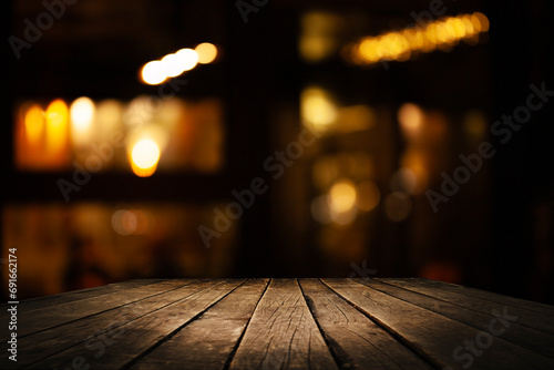 Empty dark wooden table in front of restaurant abstract blurred bokeh background. can be used to demonstrate or mount your products. Layout for space