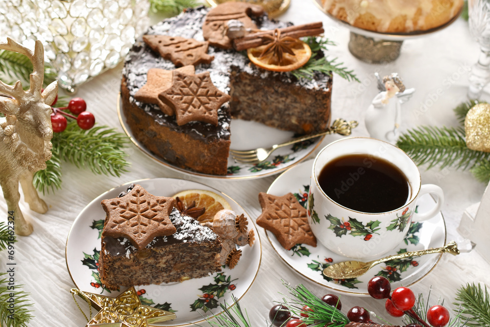 Christmas pastry called Japanese poppy seed cake with chocolate glaze, coconut flakes and decorated with homemade gingerbread cookies and a cup of coffee Christmas pastry called Japanese poppy seed cake with chocolate glaze, coconut flakes and decorated with homemade gingerbread cookies and a cup of coffee