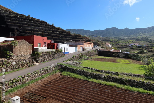 El Palmar, Buenavista del Norte, Tenerife, Spain, February 22, 2022: Cultivated fields in El Palmar next to Zahorra mountain, El Palmar, Buenavista del Norte, Tenerife, Spain photo