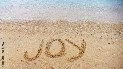 Joy - letters in sand on the beach photo
