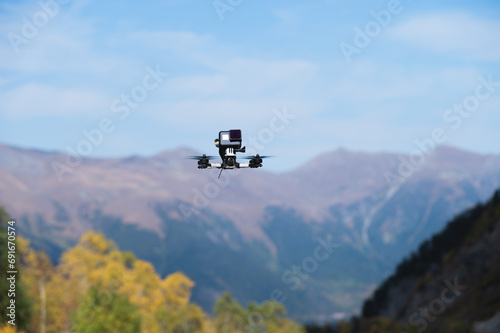 drone with an action camera films mountains in flight. close-up of an unmanned device, fpv with camera