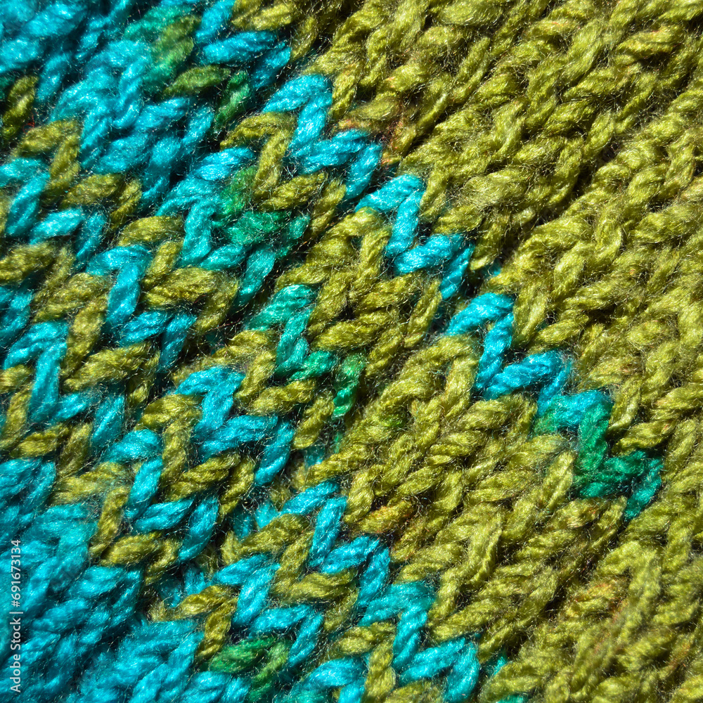 Handmade knitted fabric blue and green wool background texture