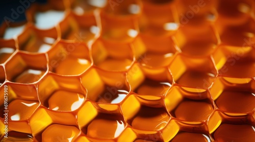  a close up of a bunch of orange hexagonal objects on a white surface with a blurry light coming from the top of the hexagonal objects.