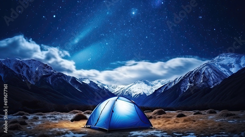 glowing tent in the mountains at night in the snow