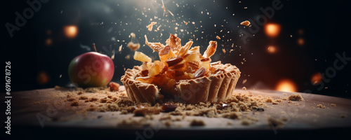 wide banner of apple pie showing filling and flying ingredients and crumbs , homemade recipe of sweet dessert menu with copyspace photo