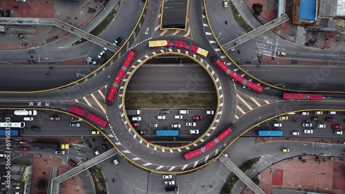 Aerial drone shot of Roundabouts in Bogota, Colombia, Latin America. Traffic in Bogota, Transmilenio. Dedicated busway on the top level. Famous roundabout full of red buses. High quality 4k footage.
