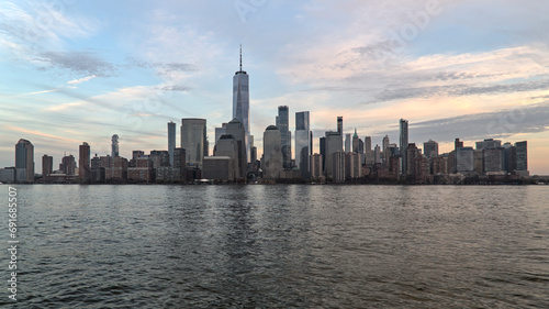 downtown manhattan skyline view (new york from jersey city) travel tourism destination (after sunset, dusk, night, dark) water reflection in hudson river (world trade center detail)