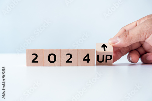 Wooden blocks with new year 2024, arrow up icons on white background, Business development and growth 2024 concept. action schedule calendar strategy future vision startup plan resolution celebration.
