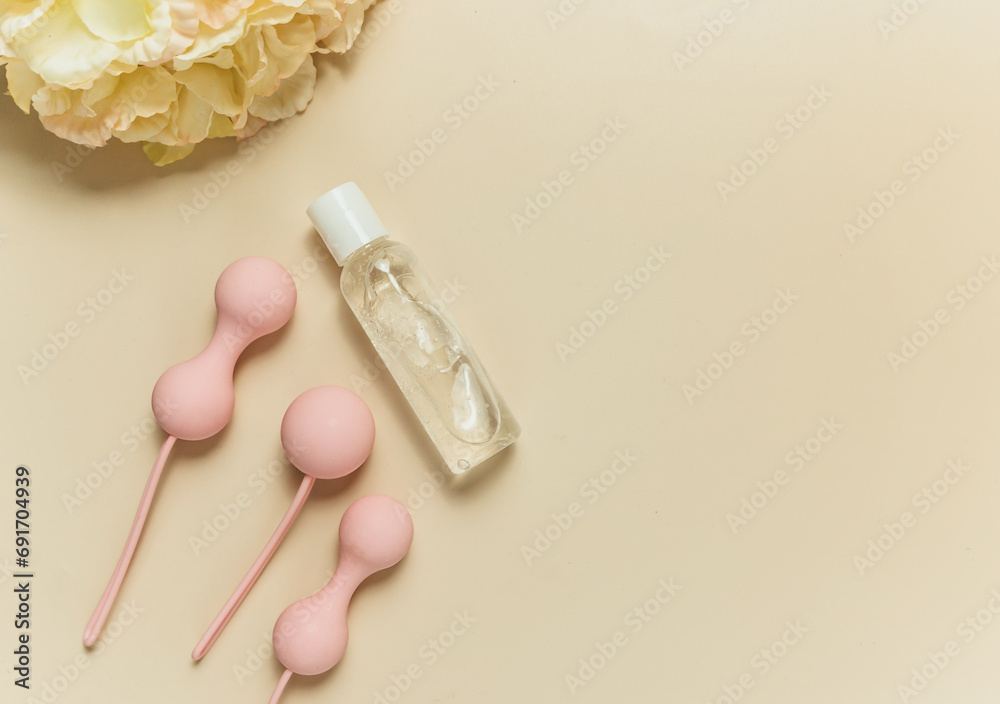 Pink balls and lubricant for special exercises for woman. Balls for intimate muscles of women. Kegel balls for strenthening the pelvic floor muscles, vaginal muscles. Mock up. Close up Pink balls and lubricant for special exercises for woman. Balls for intimate muscles of women. Kegel balls for strenthening the pelvic floor muscles, vaginal muscles. Mock up. Close up