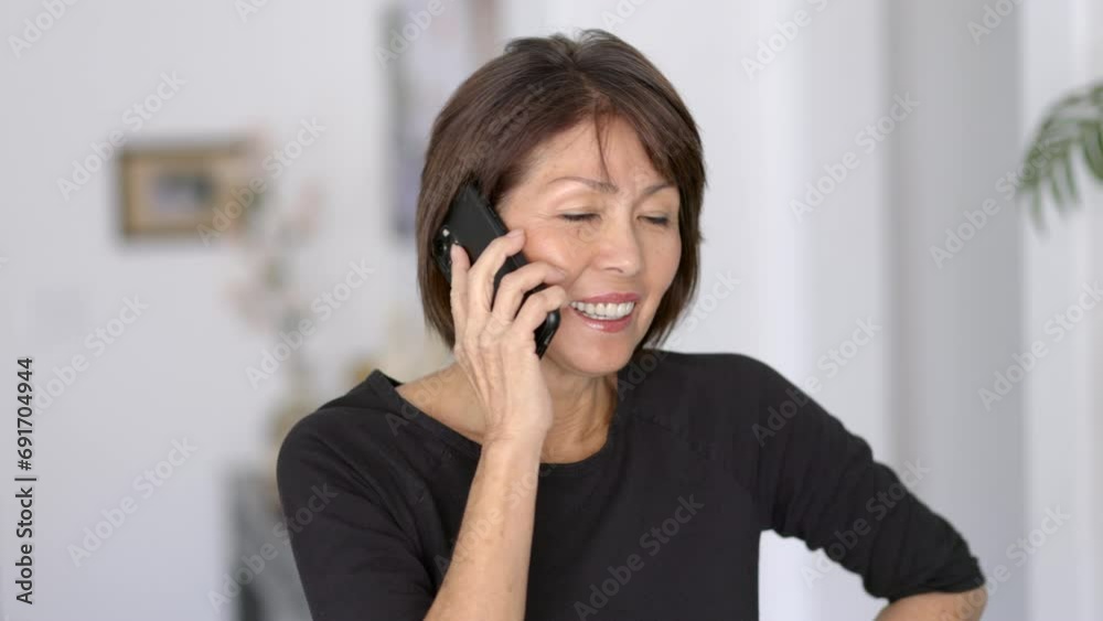 Closeup attractive stylish woman smiling laughing enjoying talking on mobile cell smartphone Closeup attractive stylish woman smiling laughing enjoying talking on mobile cell smartphone