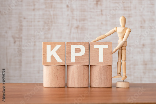 There is wood cube with the word KPT. It is an abbreviation for Keep, Problem, Try as eye-catching image. photo