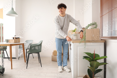 Young man wrapping basket w...