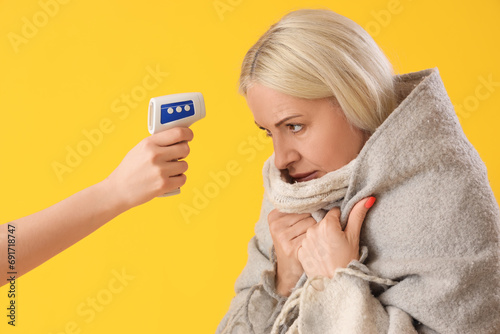 Ill mature woman measuring ...