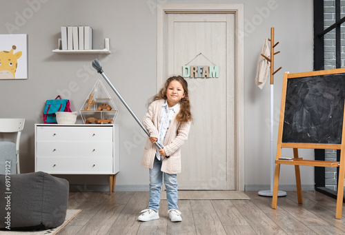 Cute little girl with broom...