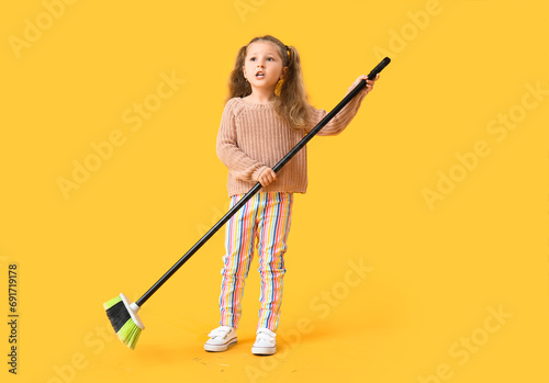 Cute little girl with broom...