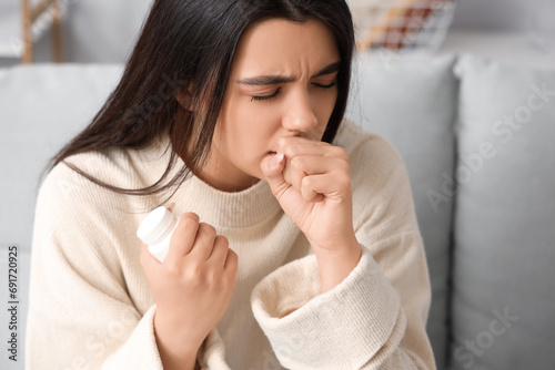 Sick coughing woman with pills at home photo