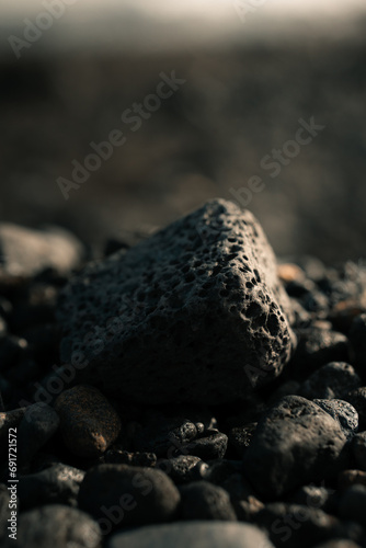 Black volcanic rock, porous stone on a beach