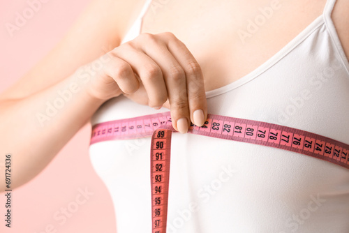 Woman measuring her breast ...