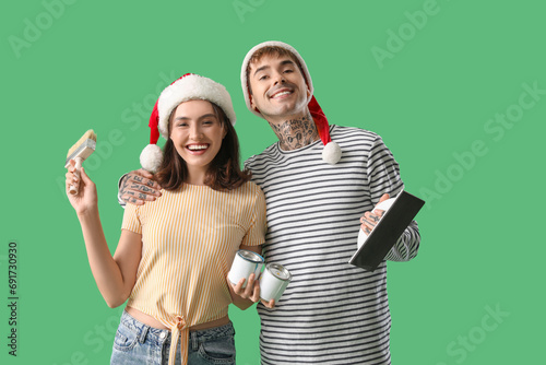 Young couple in Santa hats ...