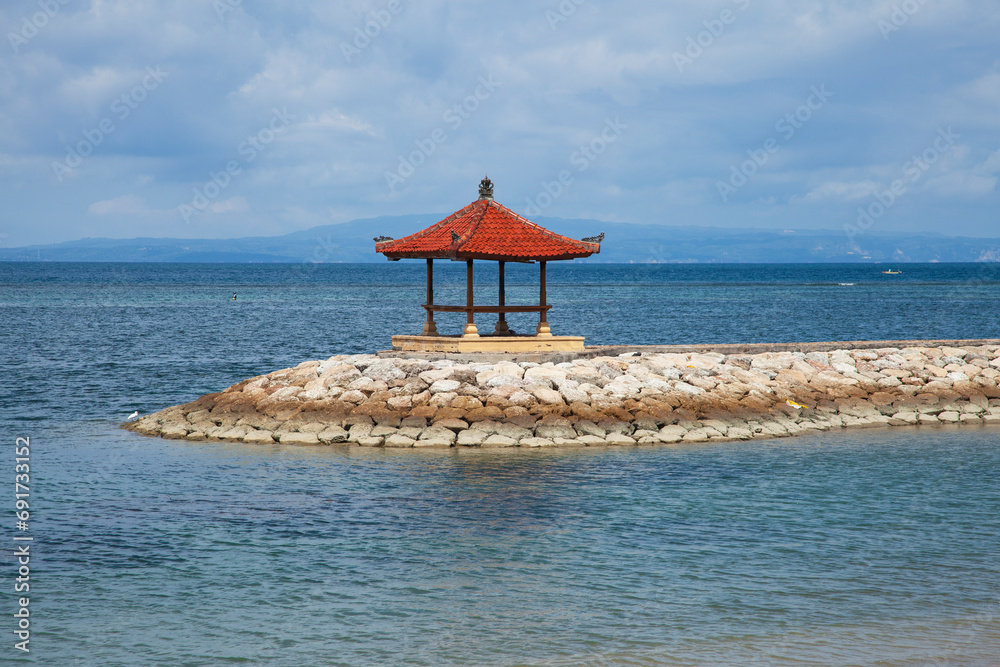 Karang Beach, Sanur, Bali, Indonesia with breakwater and pavilion. Karang Beach, Sanur, Bali, Indonesia with breakwater and pavilion.