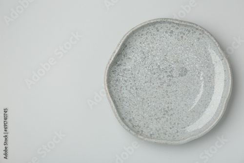 Beautiful ceramic plate on light gray background, top view. Space for text