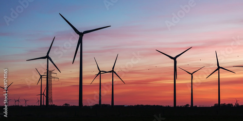 Windräder nach Sonnenuntergang im Abendrot mit Wolken bei Schülp in Dithmarschen, Schleswig-Holstein. photo