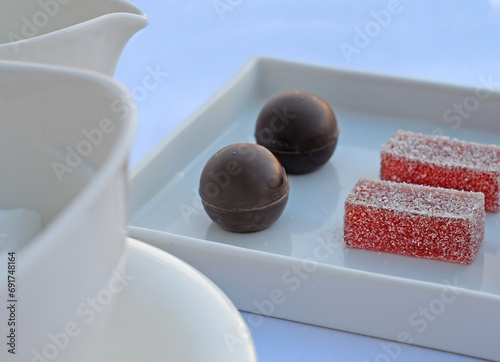 Luxurious dessert with chocoate balls and Turkish fruit on white plate photo