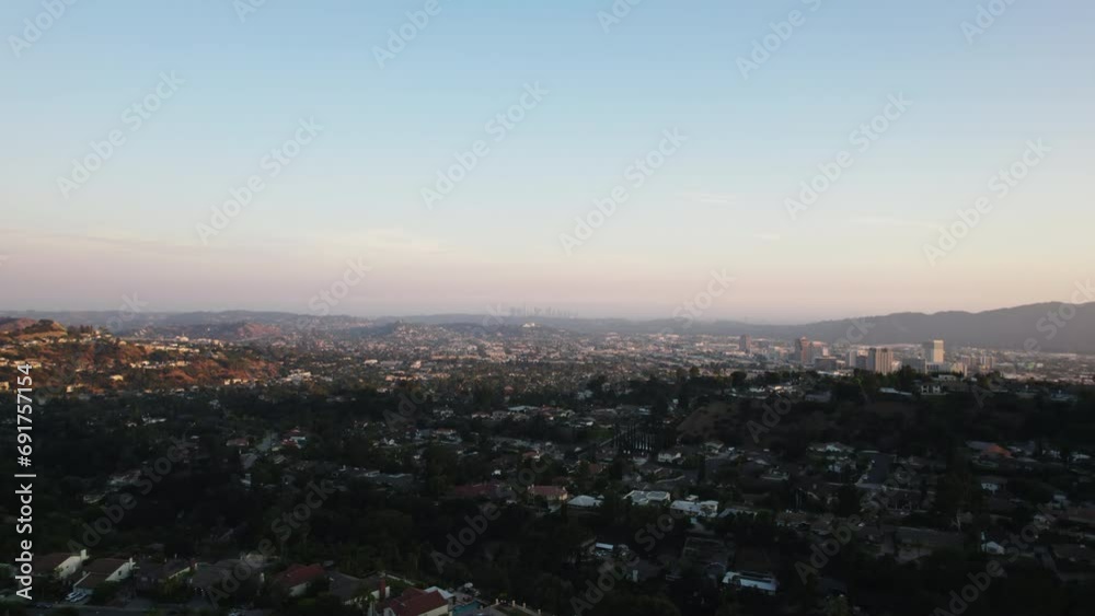Forwards fly above residential suburb of metropolis at golden hour. Aerial panoramic view of large city. California, USA Forwards fly above residential suburb of metropolis at golden hour. Aerial panoramic view of large city. California, USA
