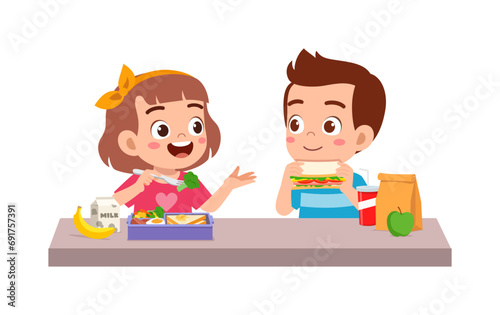 little kid having lunch with friend in school