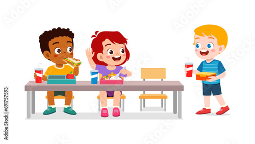 little kid having lunch with friend in school photo