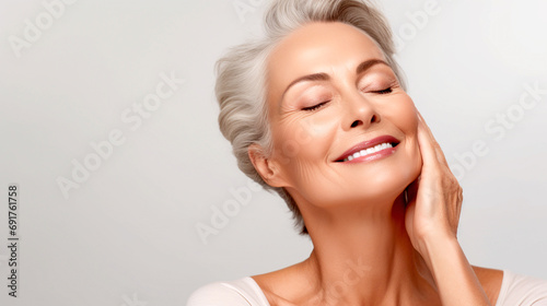 Spa - Happy Smiling Mature Woman Showing Perfect Skin in Studio. Horizontal Image.