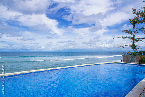 Infinity pool overlooking beach. beachfront swimming pool © Ibenk.88