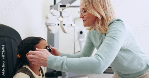Eye exam, optometry and optician with frame for child for testing vision, sight and glasses for eyes. Healthcare, medical equipment and young patient with woman for prescription lens in clinic photo