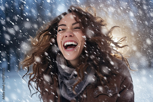 a beautiful woman laughing in the snow © Kien