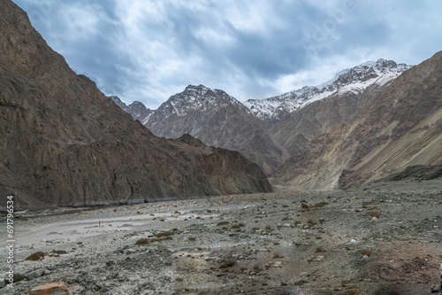 Scenic view of Himalayas and Ladakh ranges. Beautiful barren hills in Ladakh with dramatic clouds in the background. View from the road from Nubra Valley to Turuk. 