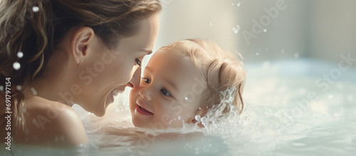 Mother and baby bonding  mommy and infant taking a bath  family relationship concept  wide-shot web banner