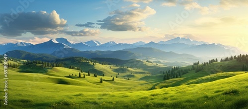 Summer evening in the mountains, with greens meadows, slopes, and hills.