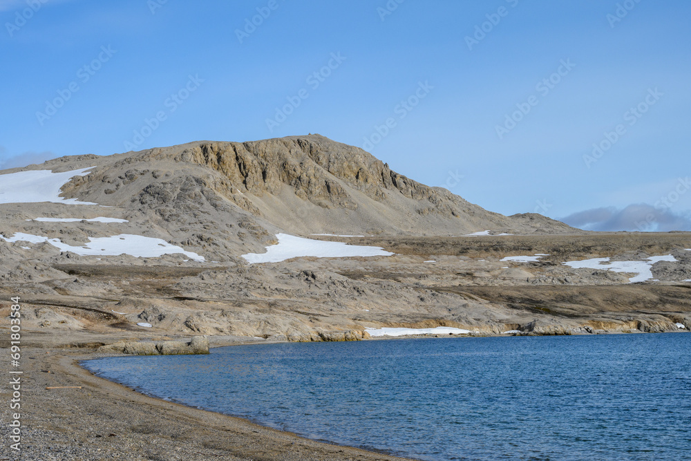 Rocky beach at Kinnvika, Murchison Fjord, Hinlopen Straight on Svalbard in the Arctic, as a nature background
