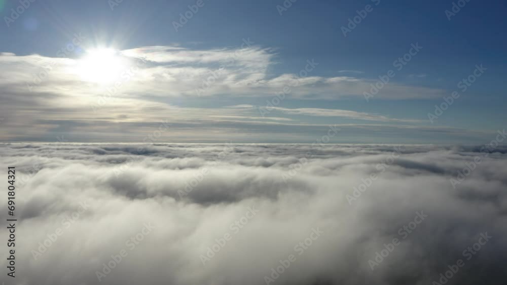 Aerial of heaven like view with white dense cloud bed and bright sun above Aerial of heaven like view with white dense cloud bed and bright sun above