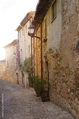 Fototapeta Naklejka Na Ścianę i Meble -  Spain. Coast of the Costa Brava. Catalonia. Streets of a small town. Old village in Spain. Charming old streets. A typical village with beautiful stone houses. Beautiful sunset