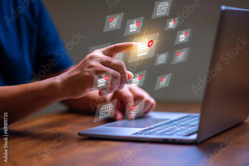 E-commerce and Online shopping concept,  Man using laptop computer with shopping cart icon for online shopping concept, e-business, ecomerce, shopping on internet, service on the online web.