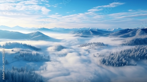 Panorama of winter foggy mountain landscape under blue sky