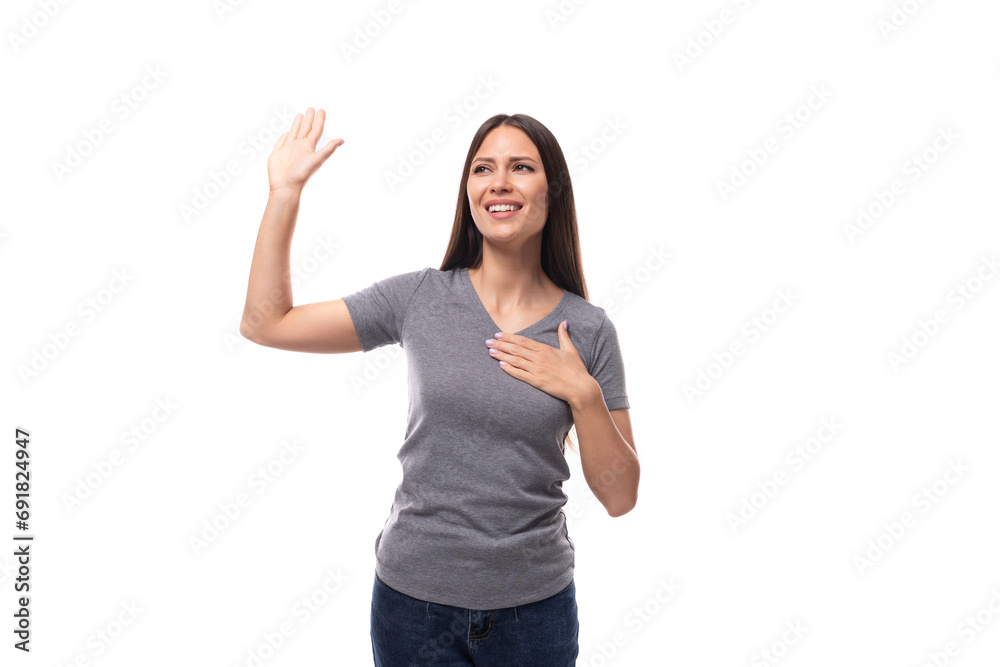 young pretty brunette woman in gray t-shirt on white background with copy space young pretty brunette woman in gray t-shirt on white background with copy space