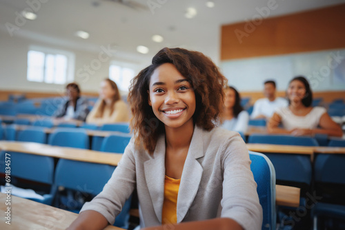 young adult woman or teenager, sitting in a school class or lecture hall in a school or university campus, joyful facial expression, tanned skin, smile, 20s