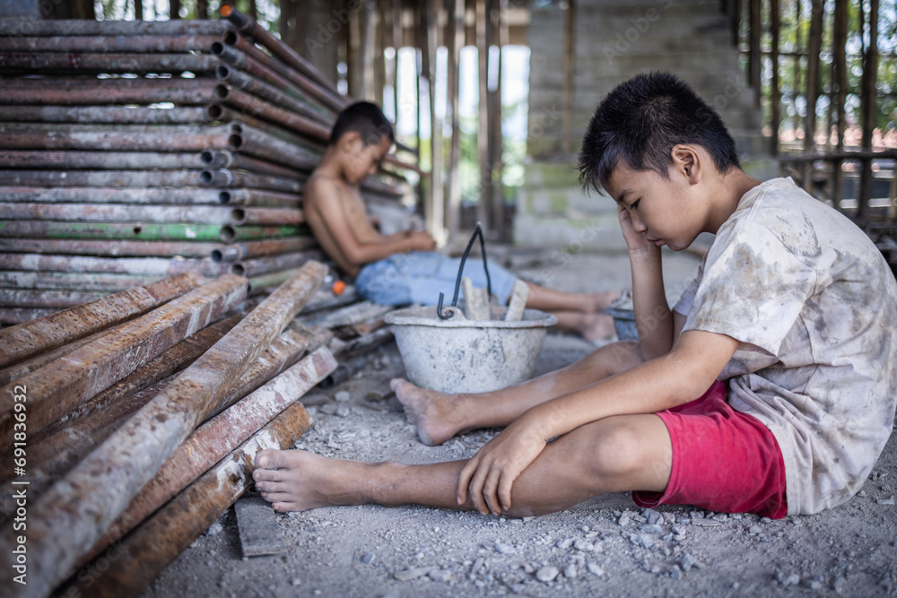 Concept of child labor, poor children being victims of construction labor, human trafficking, child abuse.